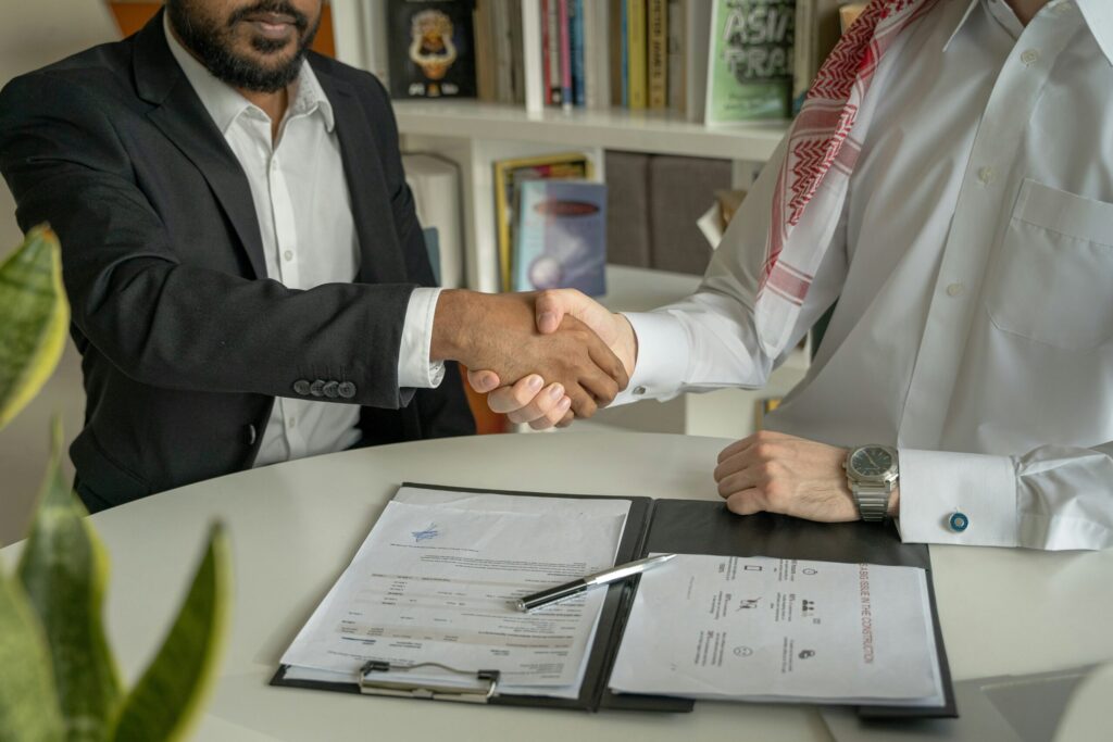 a lawyer and client shaking hands over a document