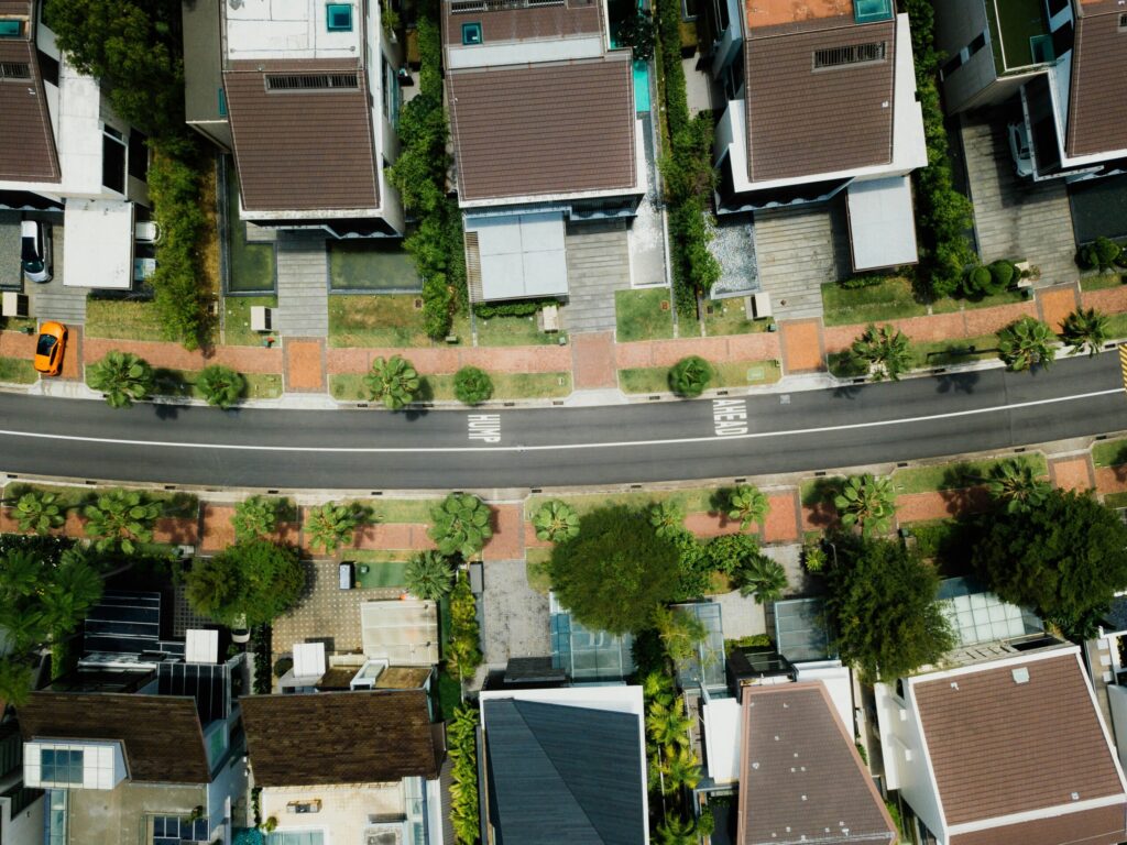 birds eye view of a residential street with houses on either side