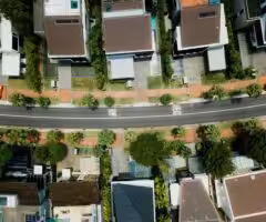 birds eye view of a residential street with houses on either side