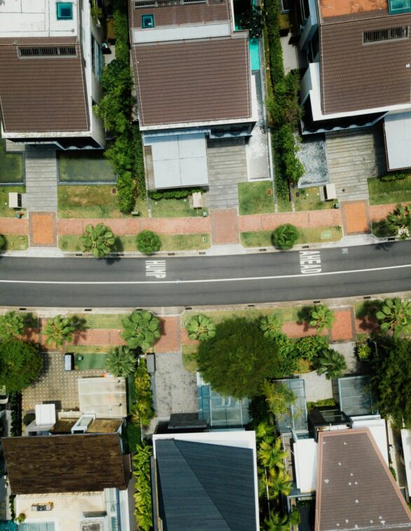 birds eye view of a residential street with houses on either side