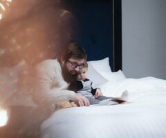 child and father reading a book