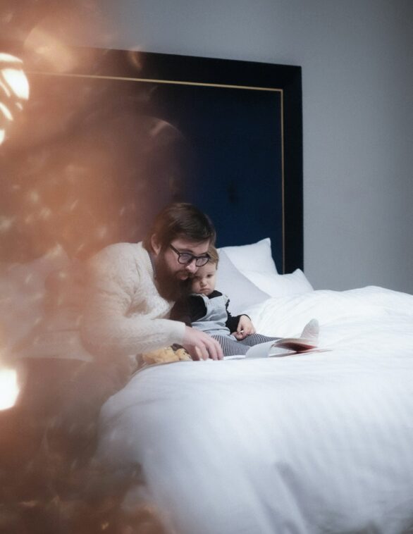 child and father reading a book