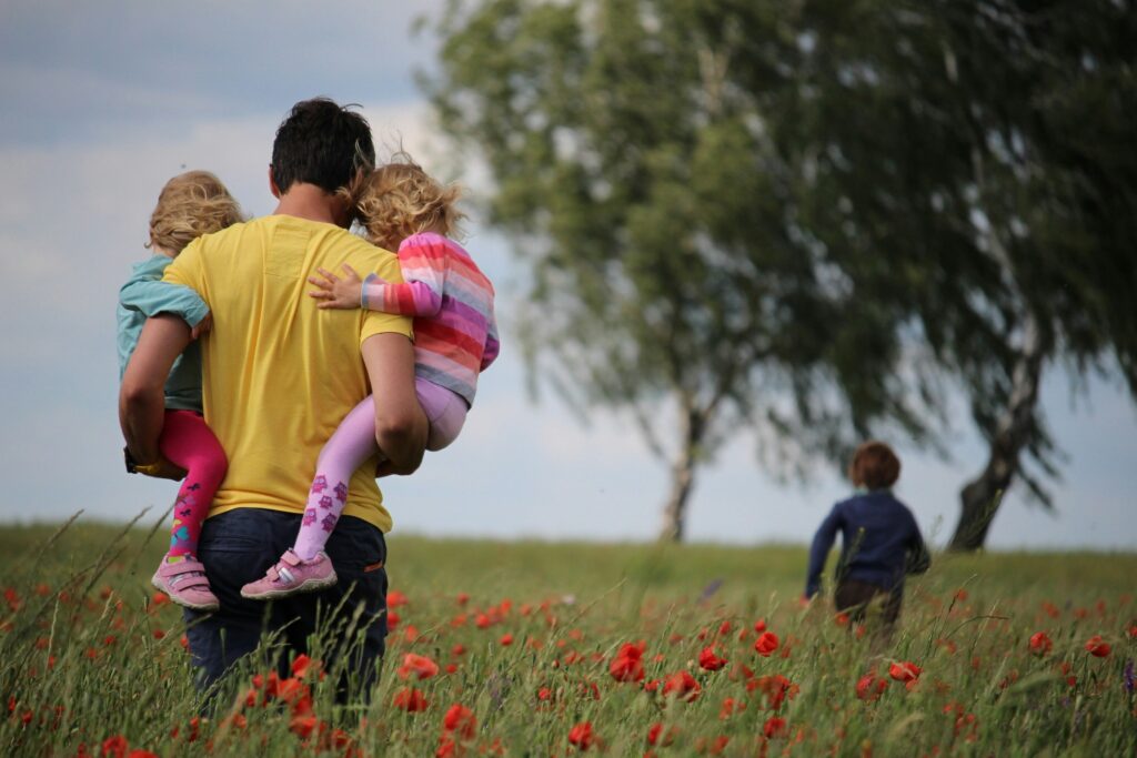 father and children in a field