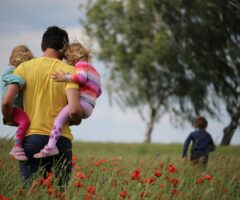father and children in a field