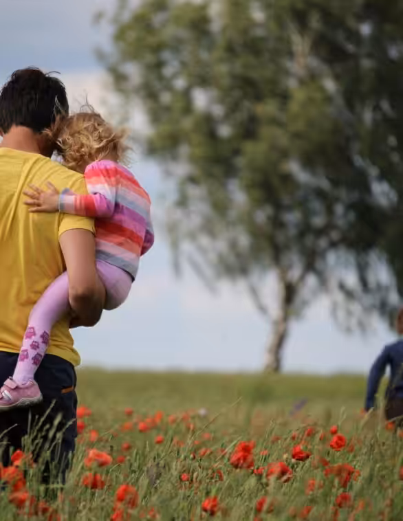 father and children in a field