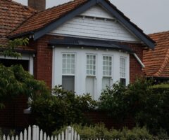 image of a house behind some bushes