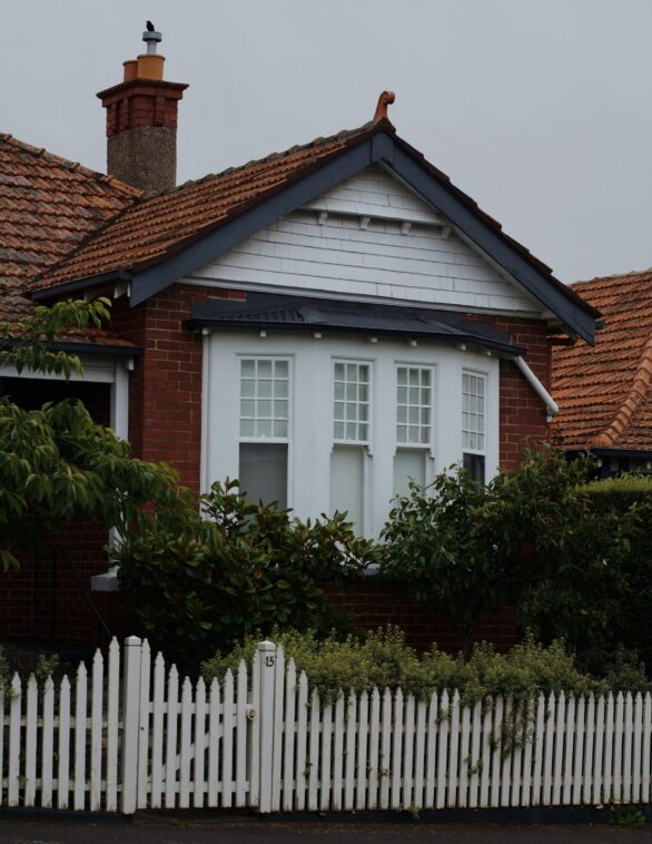 image of a house behind some bushes