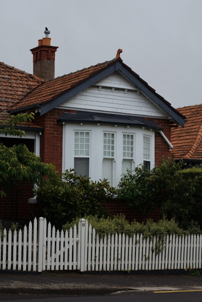 image of a house behind some bushes