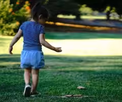 child in a park walking