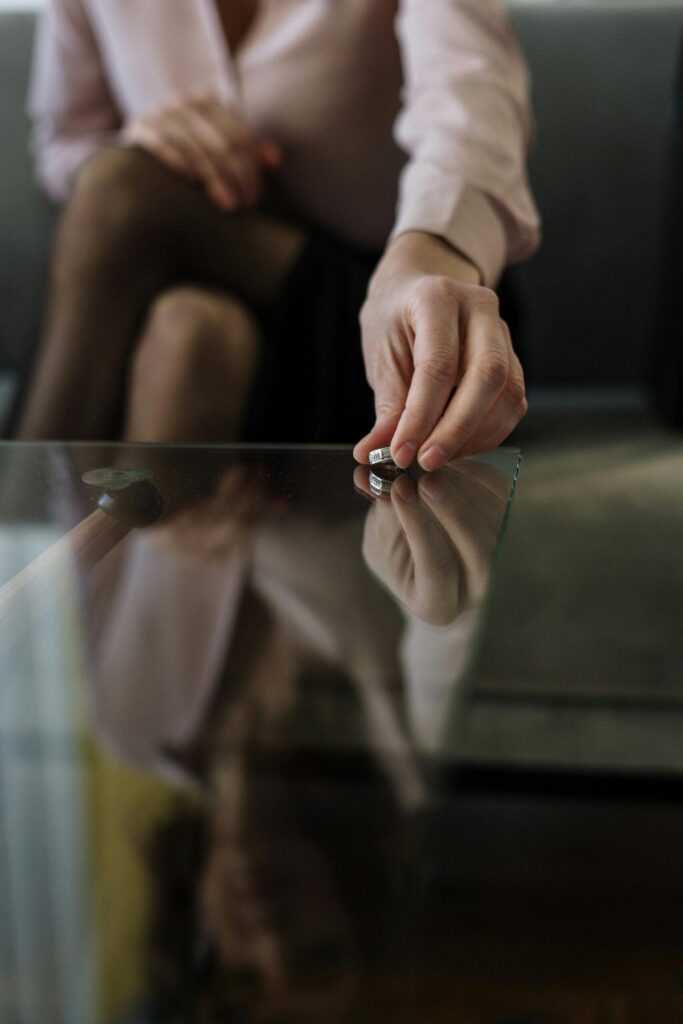 woman placing her ring on a coffee table