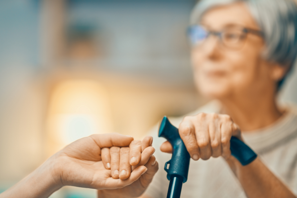 Older woman receiving assistance from a woman